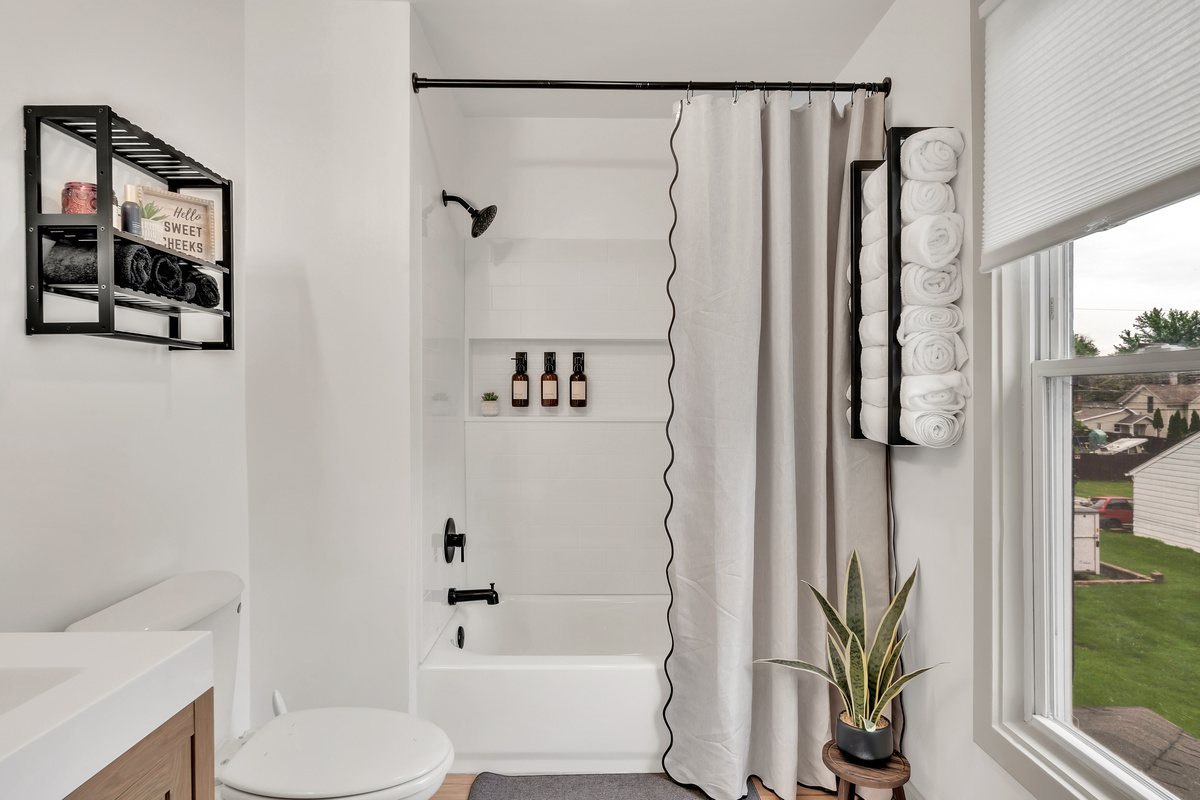 Fully renovated spa-inspired bathroom with shower/tub combo.