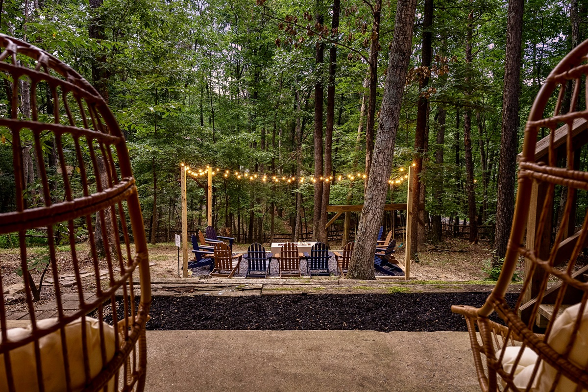 An enchanting fireside retreat—string lights, forest views, and the perfect setting for unforgettable evenings. Your private escape awaits.