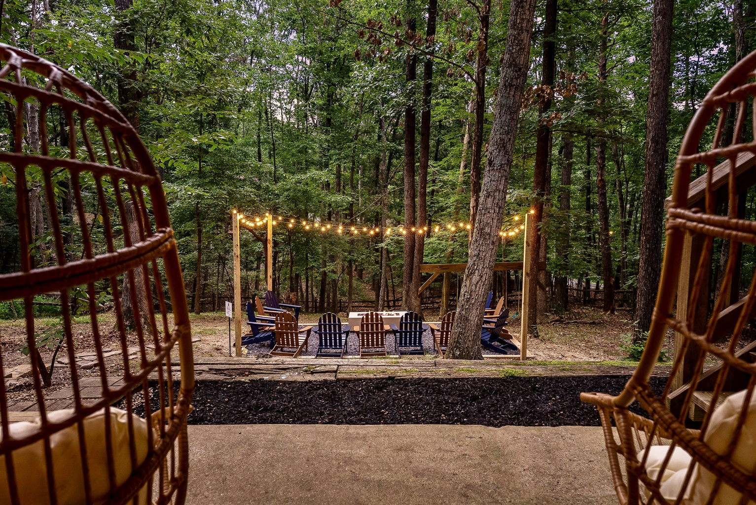 An enchanting fireside retreat—string lights, forest views, and the perfect setting for unforgettable evenings. Your private escape awaits.