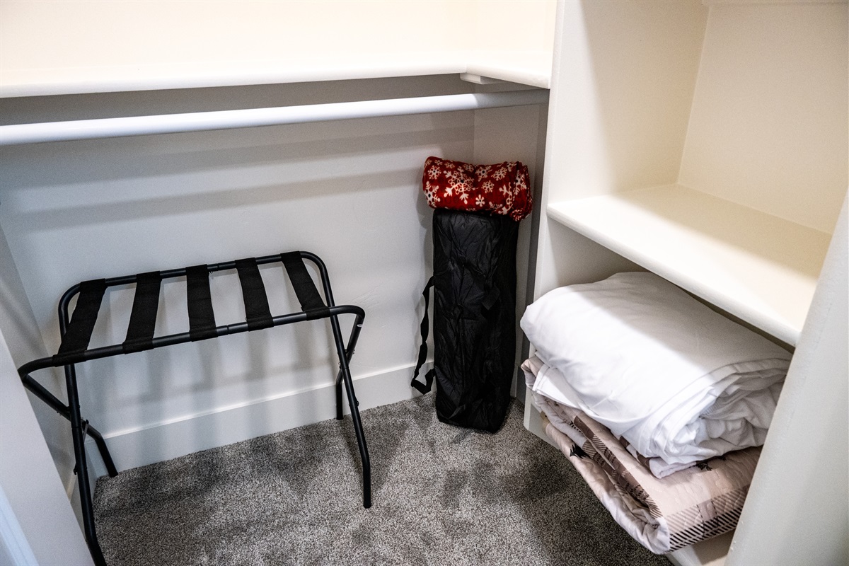 Guest essentials including a luggage rack and extra bedding for your convenience.