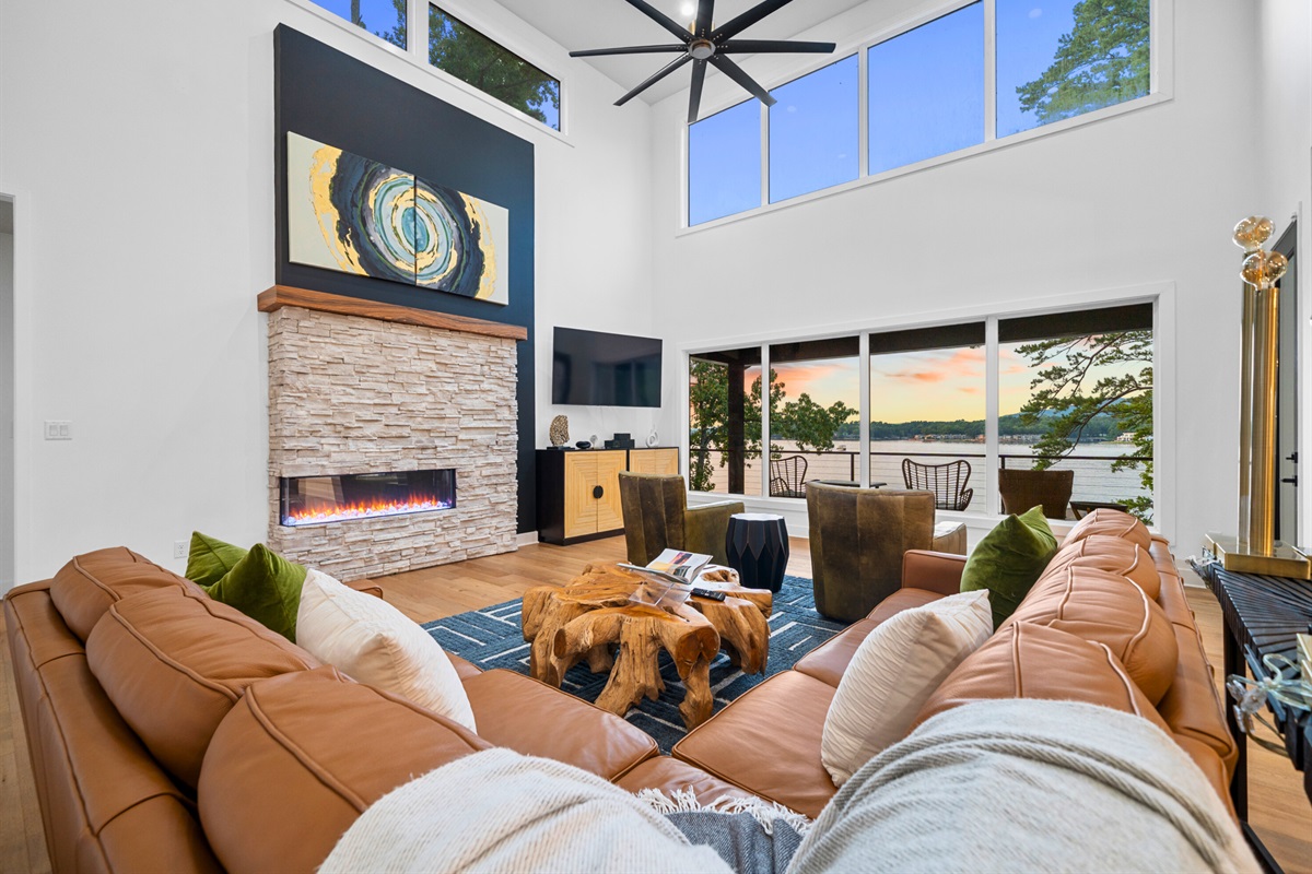 Cozy up in the great room with soaring ceilings, modern fireplace, and endless natural light.