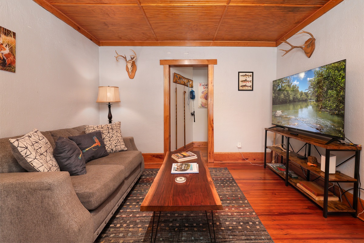 Living Room with couch, sitting area, bar stations and large TV