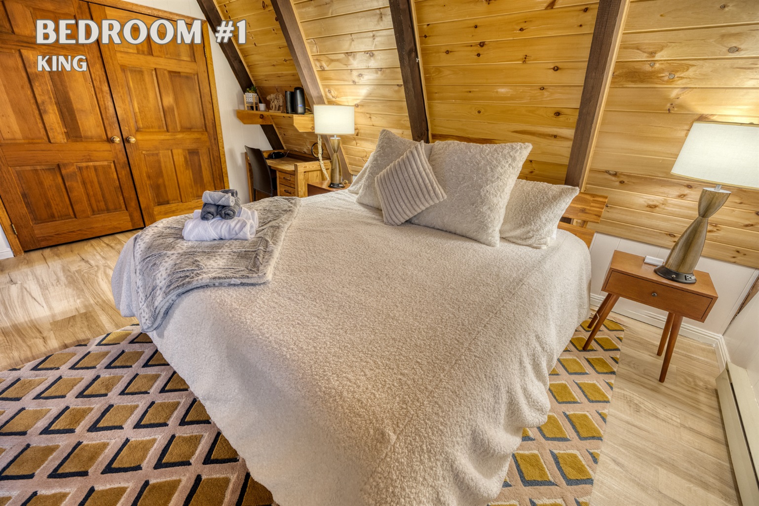 Located on the main floor, Bedroom #1 features a luxurious king-sized bed for a restful nights sleep and dedicated workspace for added functionality.