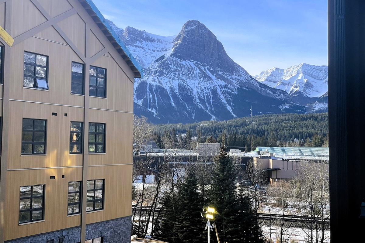 Mountains visible and railroad tracks visible from balcony. 