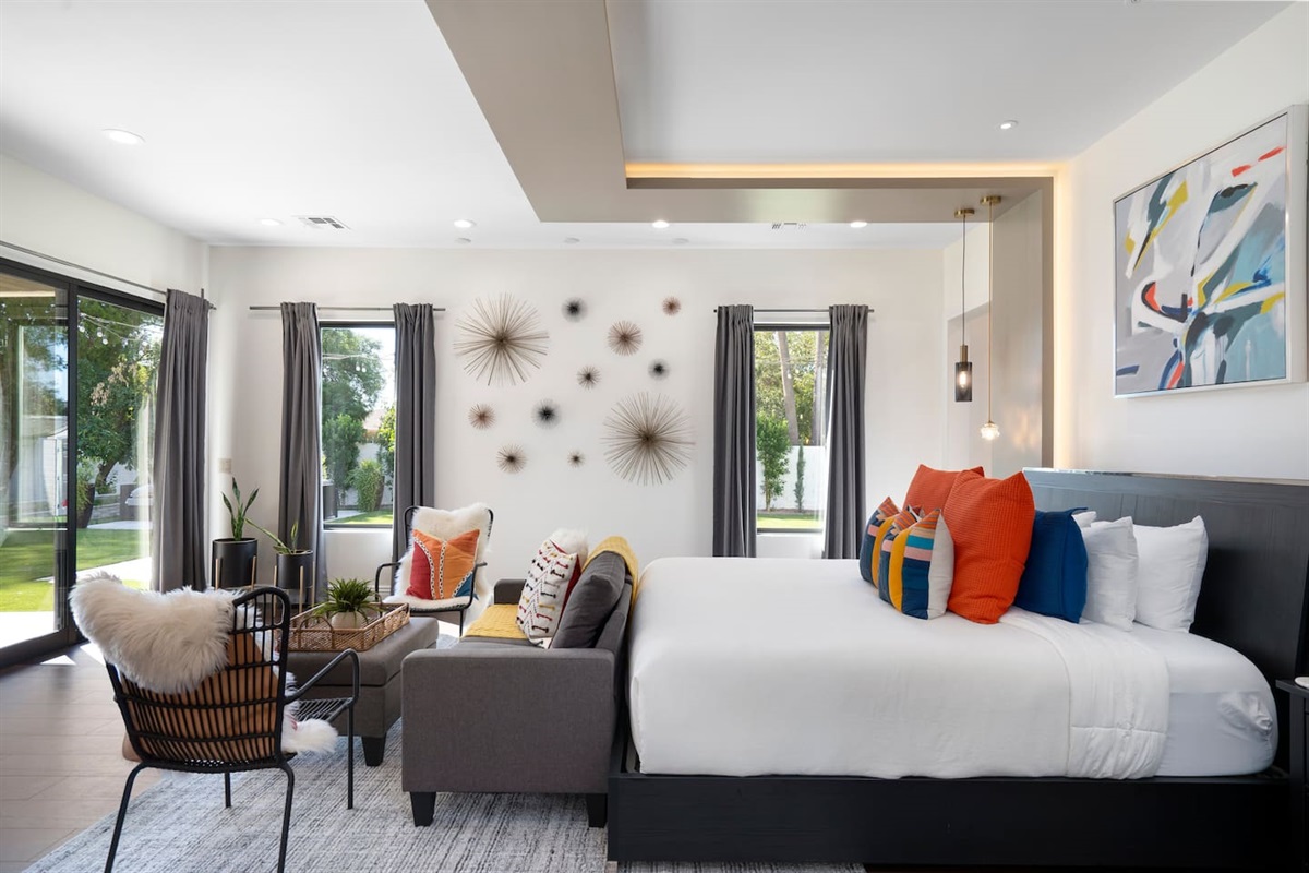 Master bedroom with direct access to backyard, king bed, seating area for comfort, a TV, large walk in and a Vegas style Master Bath.