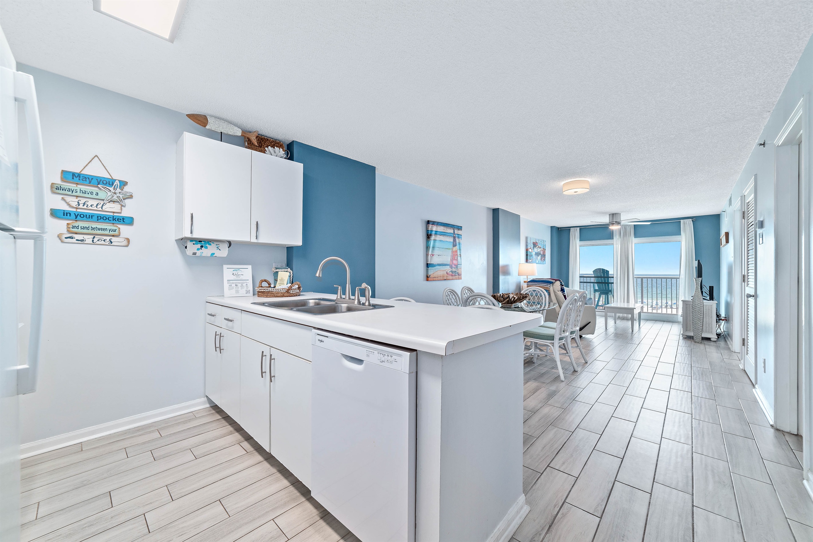 Updated kitchen with stainless steel appliances, quartz countertops, and a contemporary backsplash, offering both functionality and aesthetic appeal.