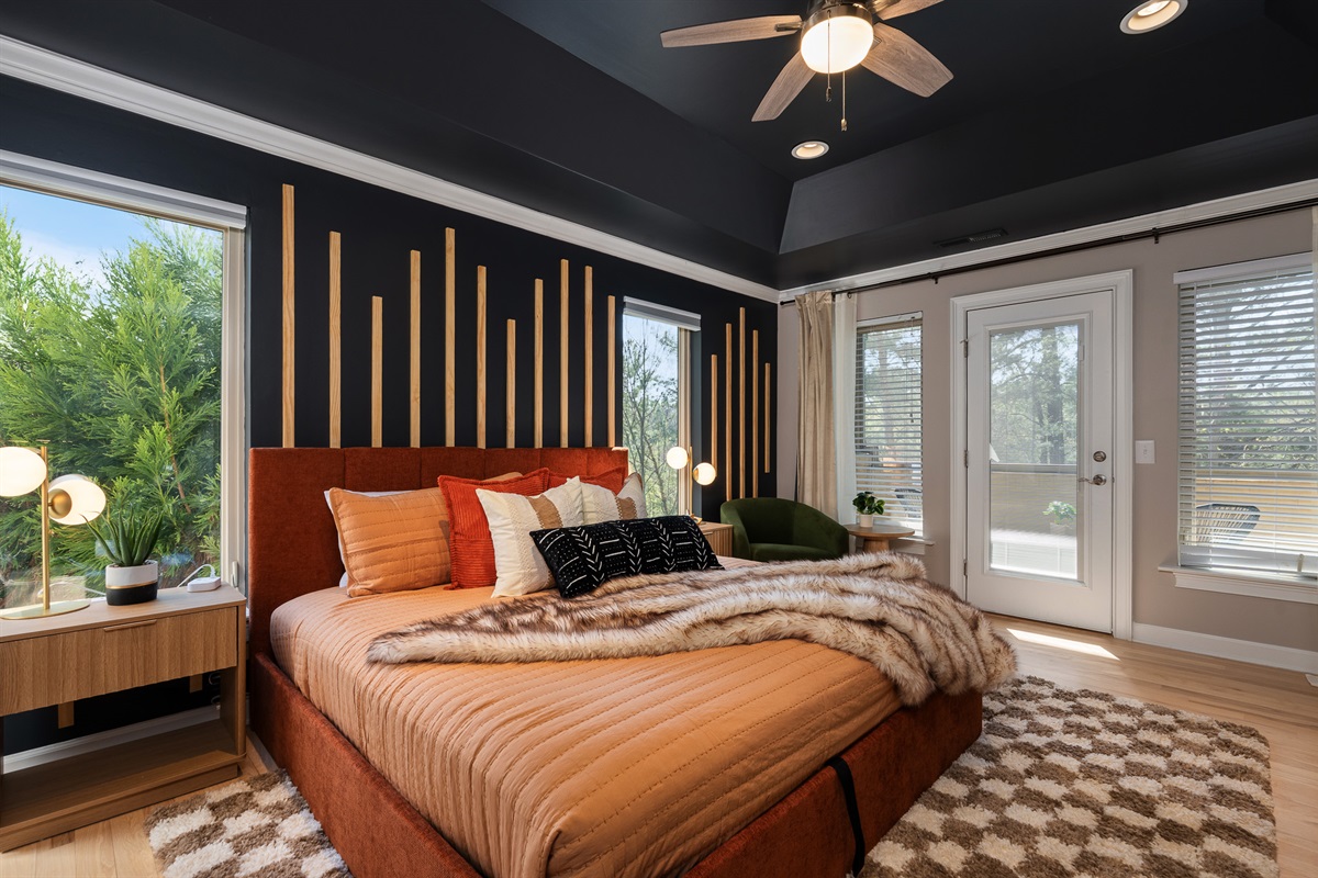 King bedroom with large windows and seating - bright, open, and comfortable for extended stays