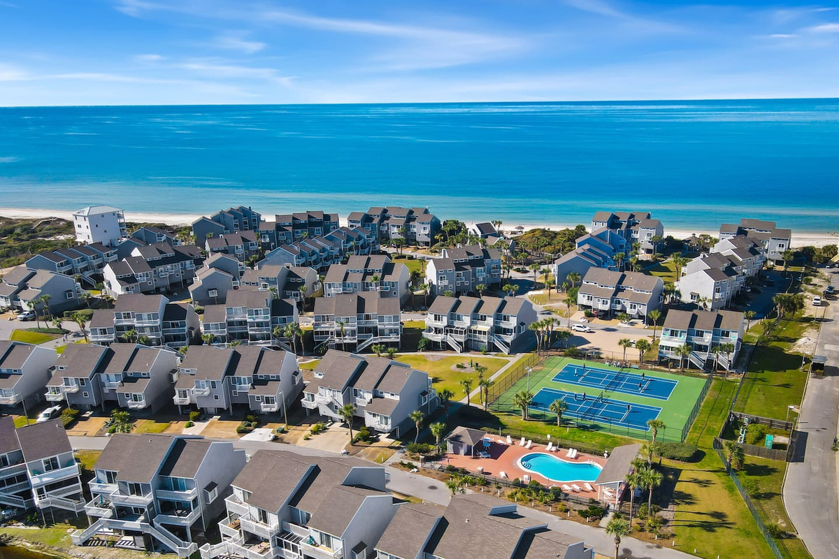 Take a break from the beach at the community pool &mdash; Gulf views from the deck, pickleball courts nearby, and a lounge chair with your name on it.