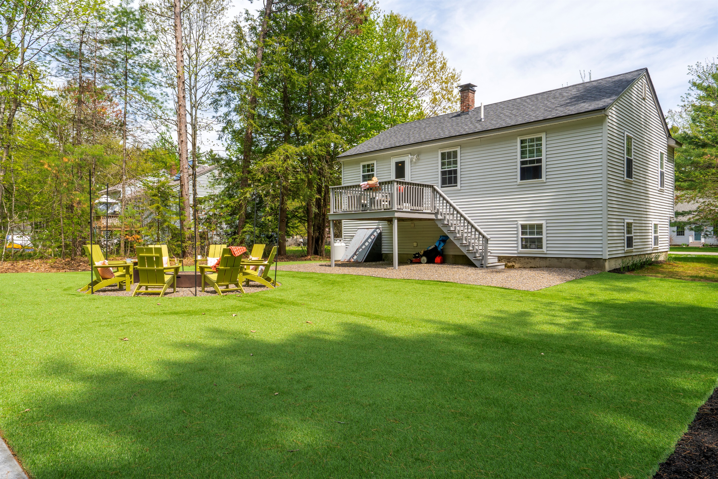A breathtaking outdoor space with comfortable seating and a lush green lawn, perfect for relaxing, gathering, and enjoying time together.
