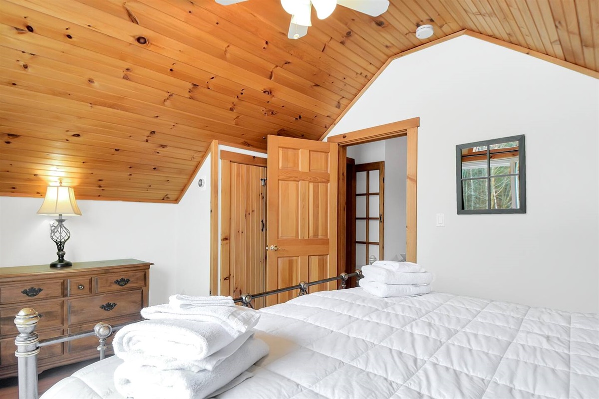 Peaceful and bright, this king bedroom includes plenty of storage and warm wood accents throughout.