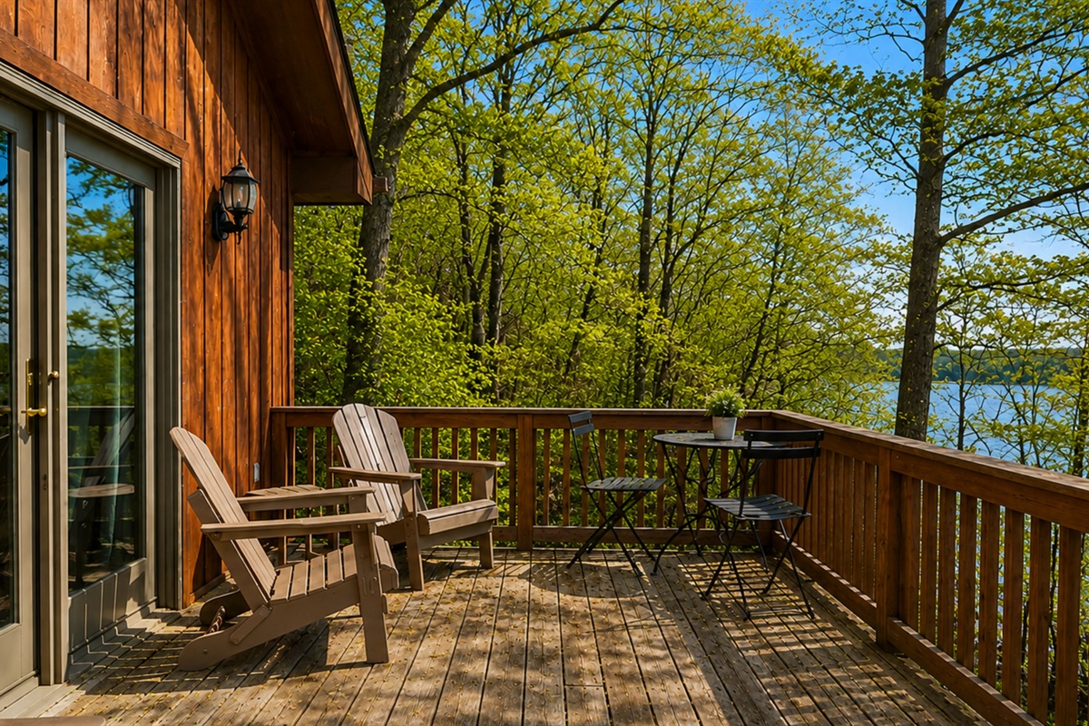 Porch 1 (directly outside of the living room) -  Enjoy the great outdoors from our spacious deck, equipped with comfortable seating and a scenic view of the surrounding forest. Ideal for relaxation or entertaining.