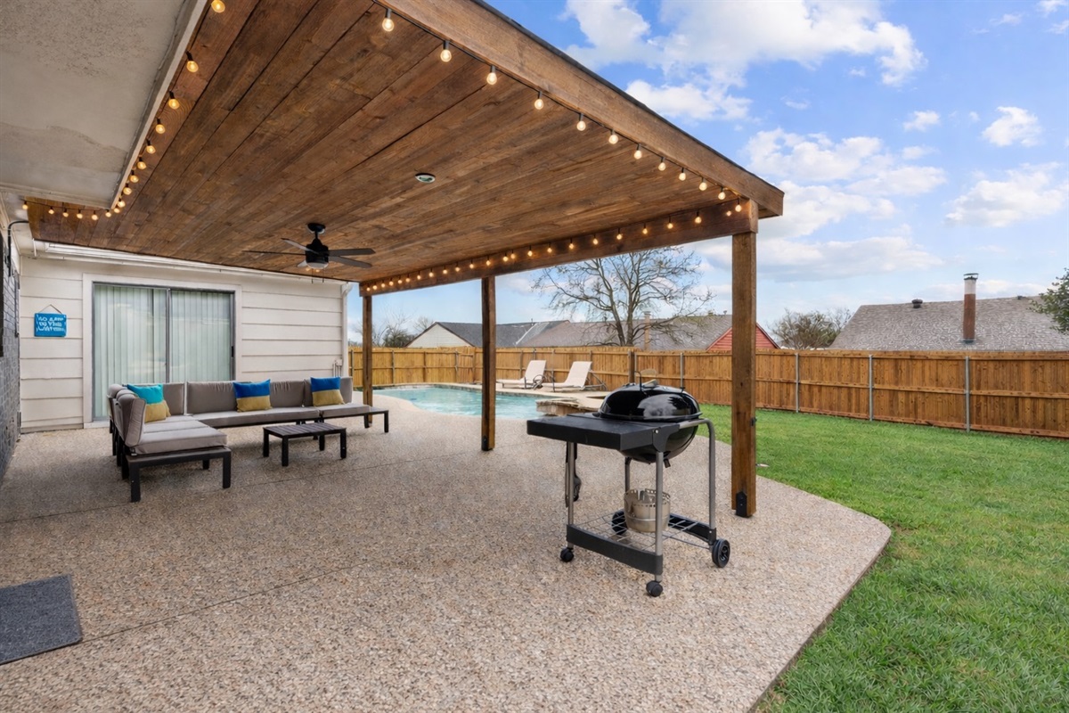 Entertain in style with this spacious covered patio and sparkling pool.