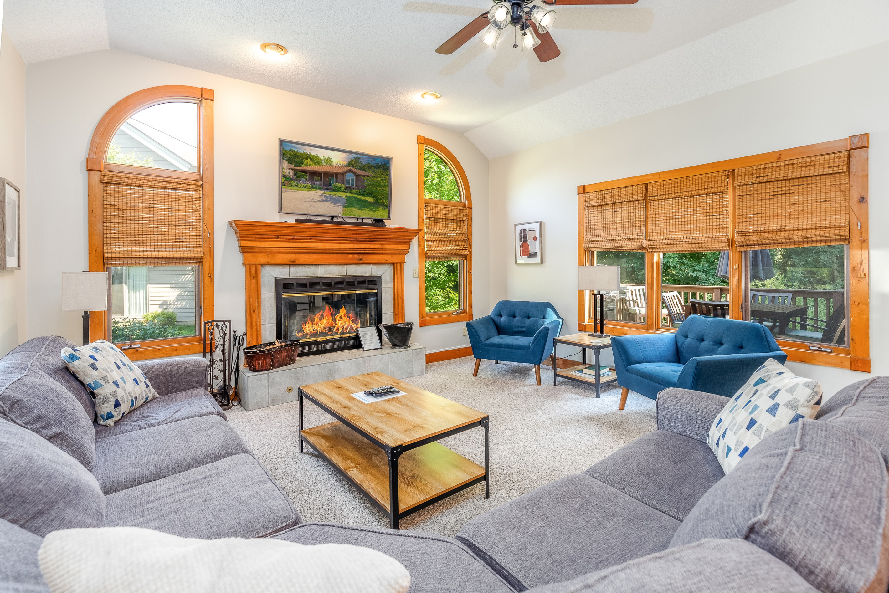 Spacious main floor living room with a large sectional sofa and wood burning fireplace