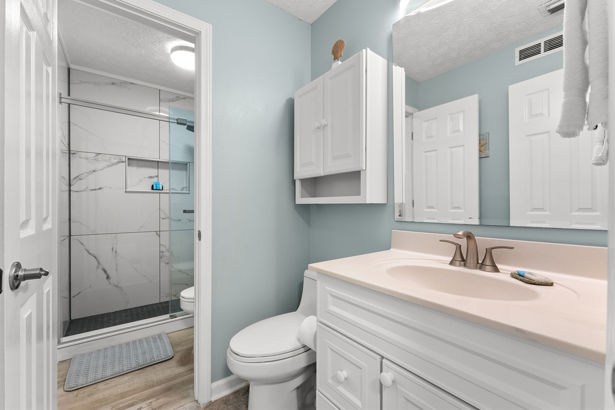 Thoughtfully designed layout with hallway half bath access to the newly tiled master shower.