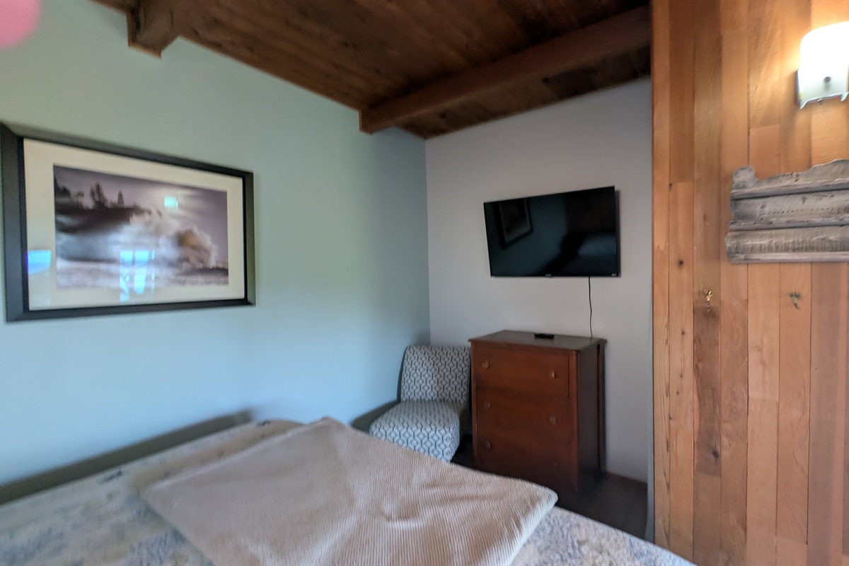 king bedroom off of living room with TV