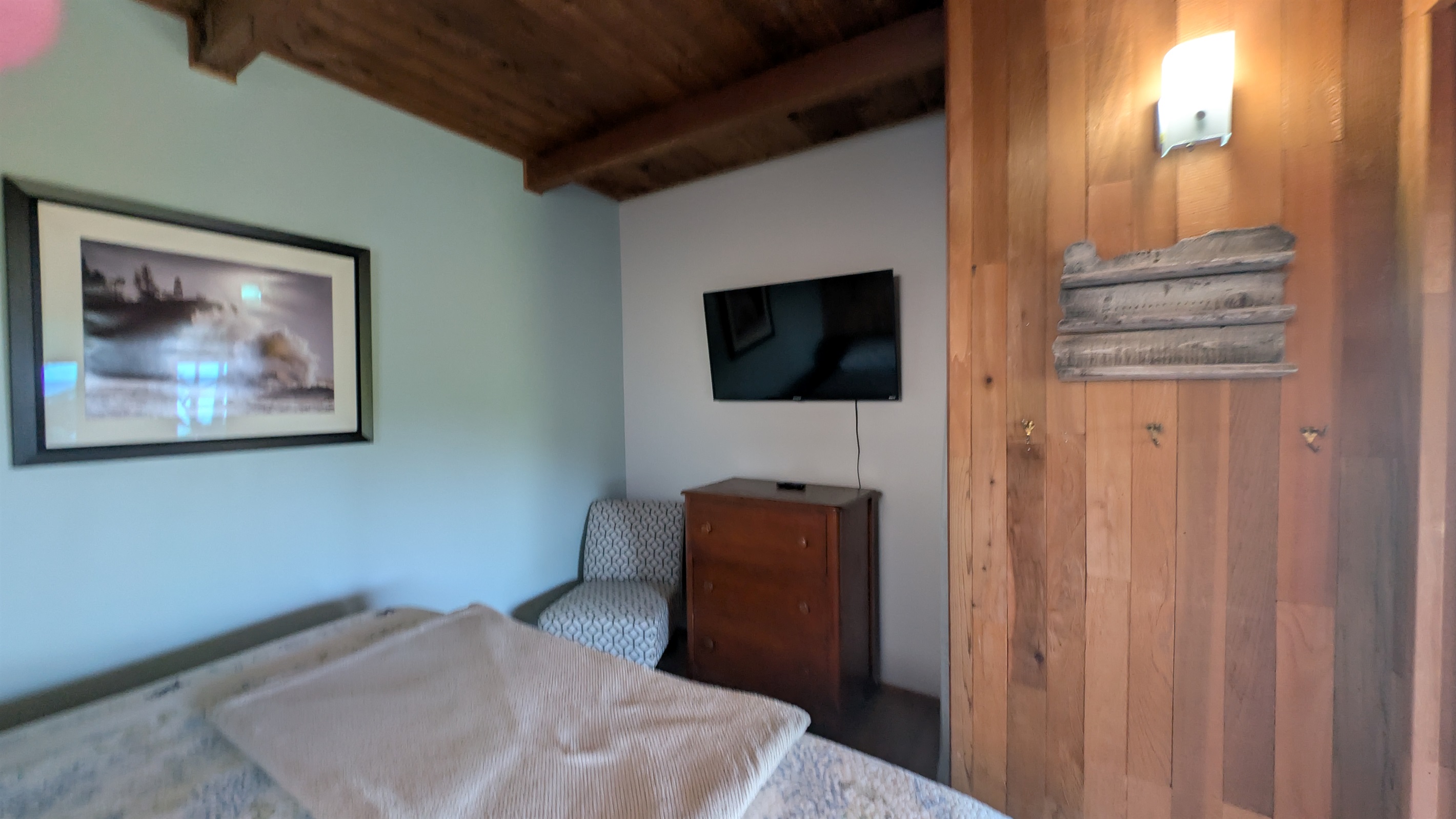 king bedroom off of living room with TV