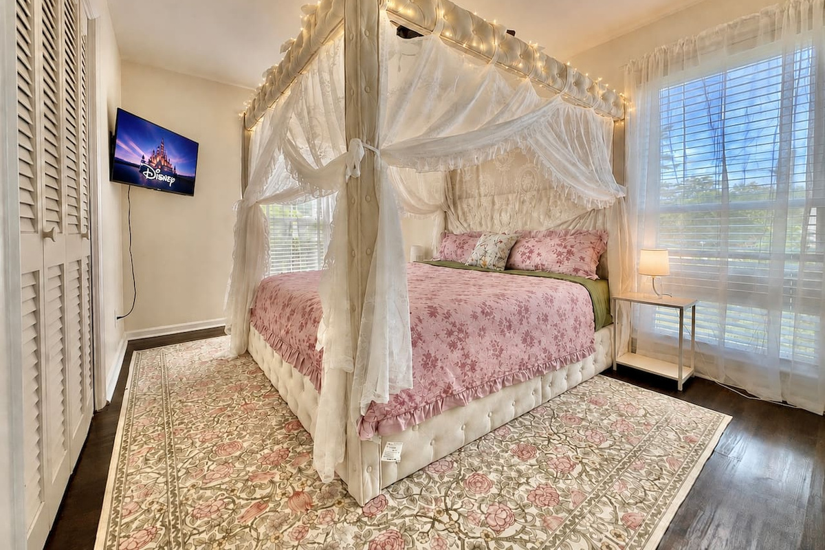 King Canopy bed with curtains & fairy lights on the top! This bedroom has a TV, Air purifier, extra bedding & Pillows located inside of the closet.