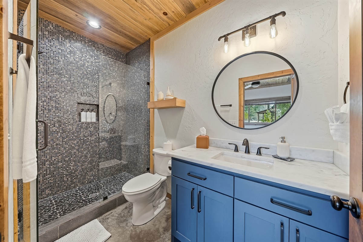 Ensuite bathroom with beautifully tiled walk-in shower.