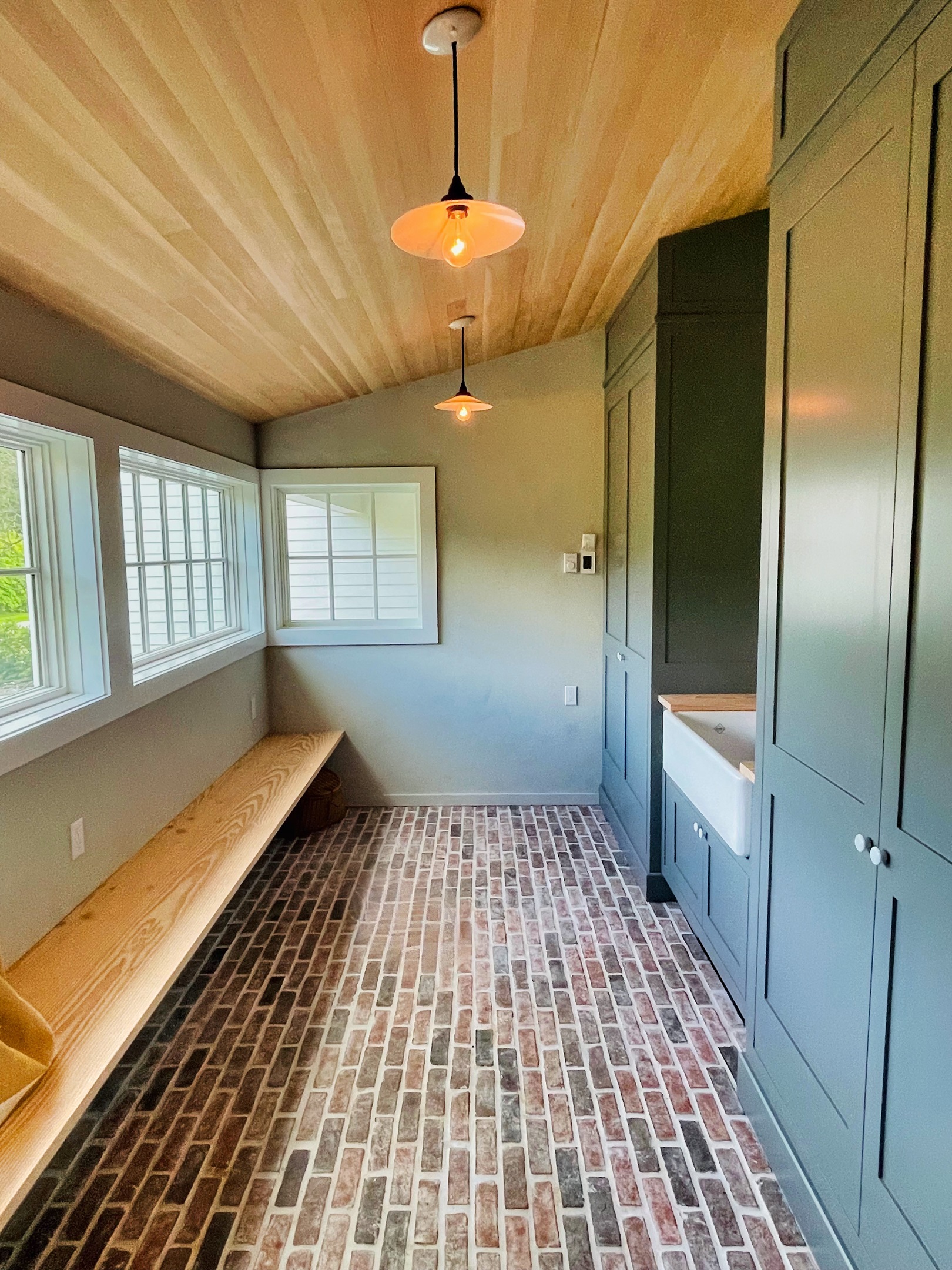 Hawk Field House - mudroom with custom brick floors.