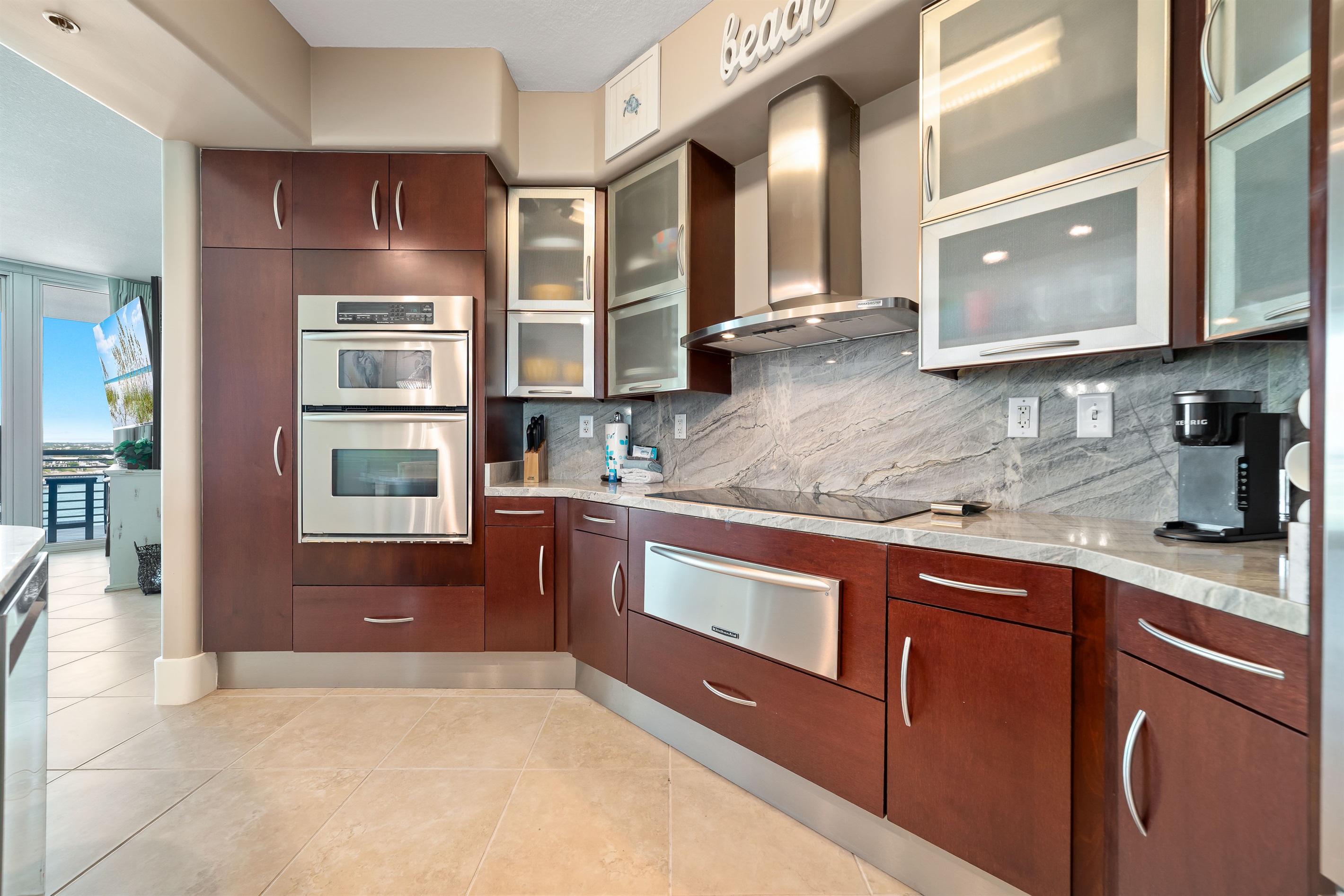 Imagine preparing delicious meals with ease in this well-appointed kitchen, all while staying connected with family and friends in the adjacent living and dining areas. This open-concept design is ideal for a relaxed coastal lifestyle.