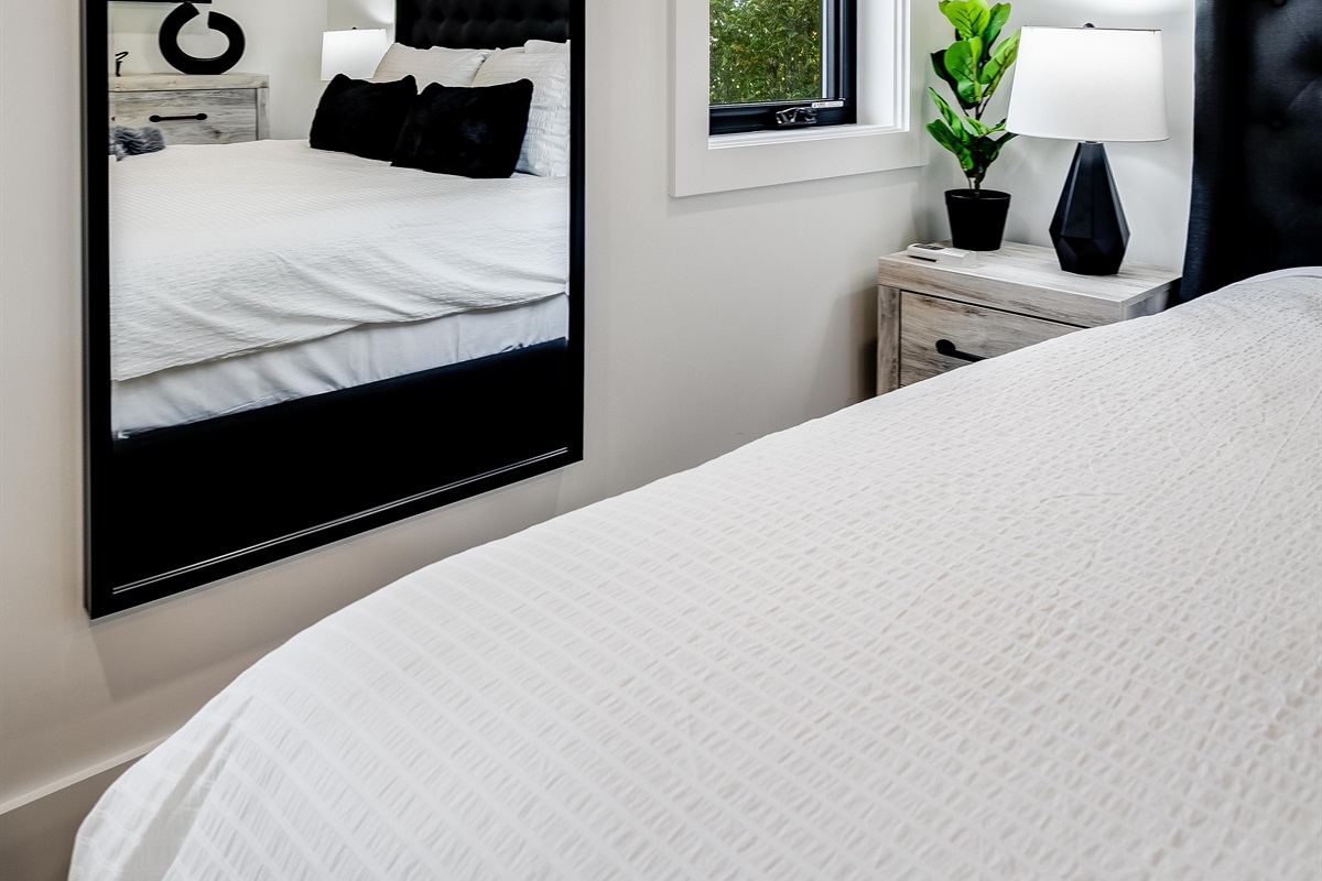 King Bedroom with Sleek nightstands with modern lamps provide functional style.