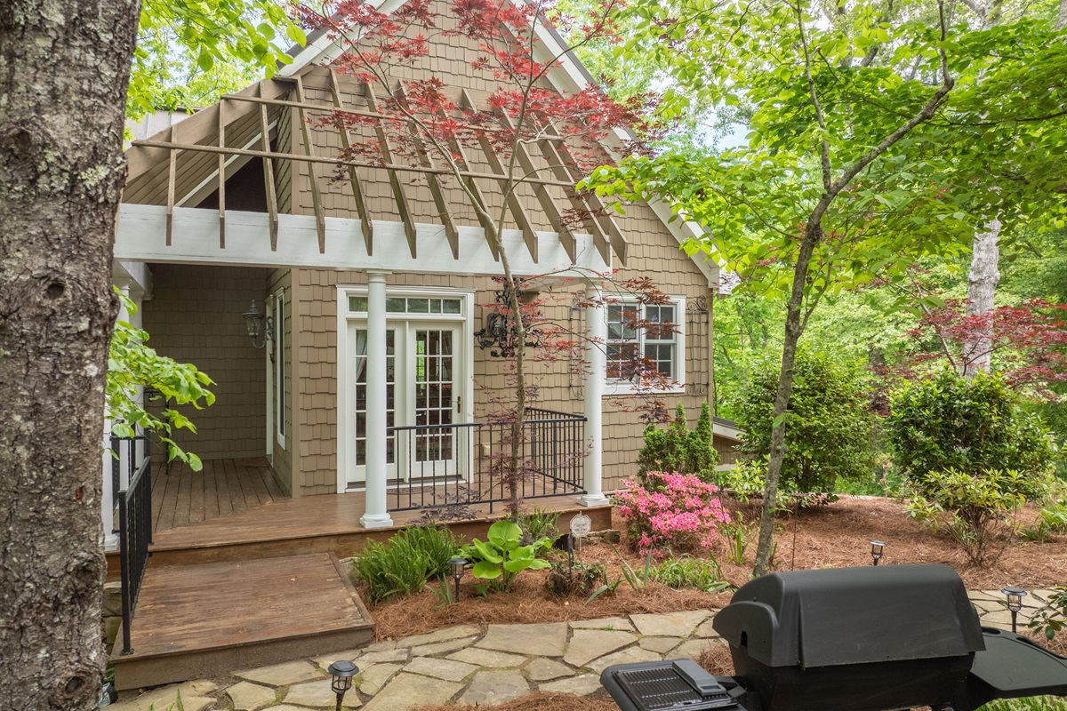 A gas grill and outdoor gathering space make it easy to enjoy cookouts surrounded by nature.