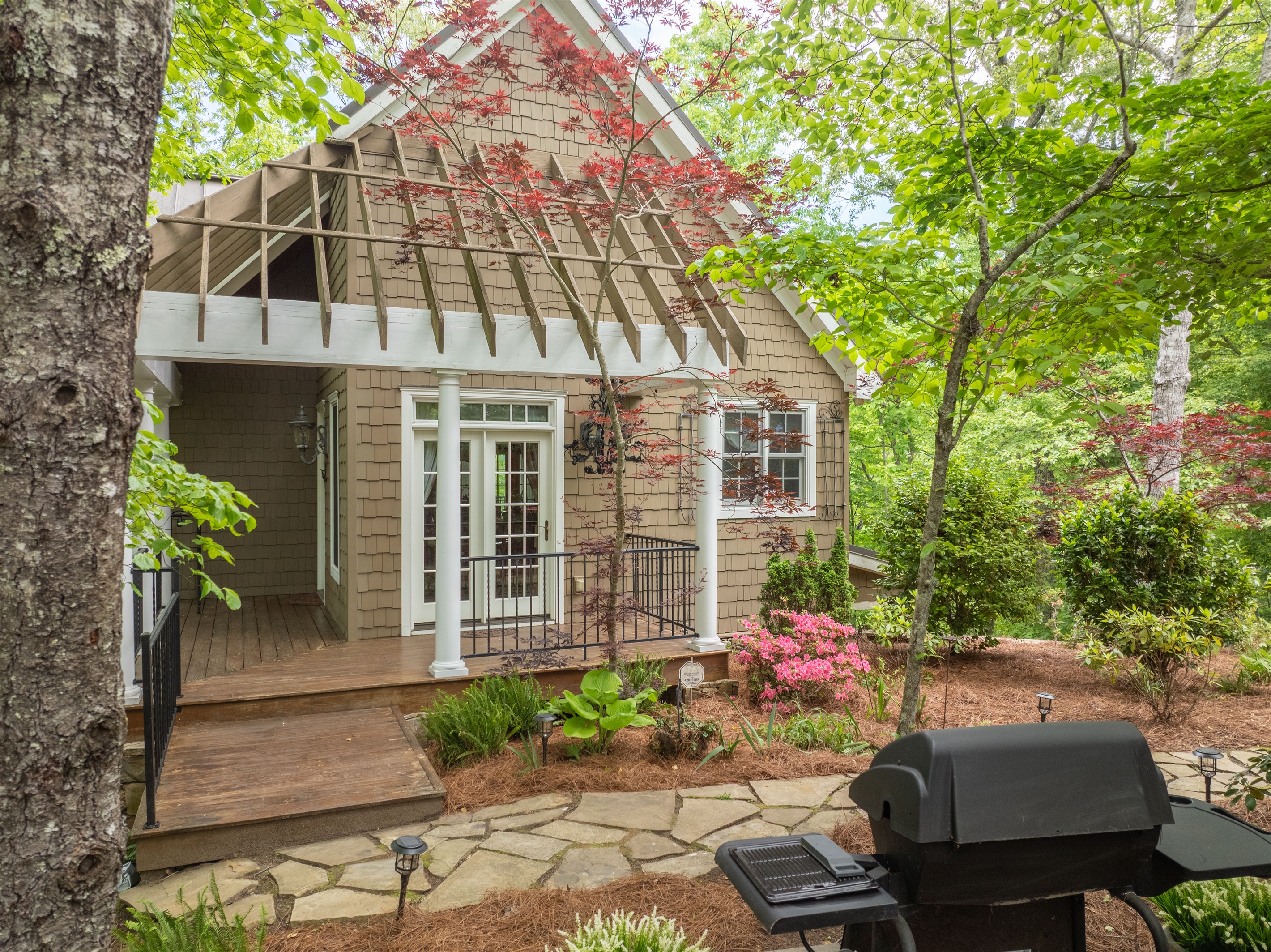 A gas grill and outdoor gathering space make it easy to enjoy cookouts surrounded by nature.