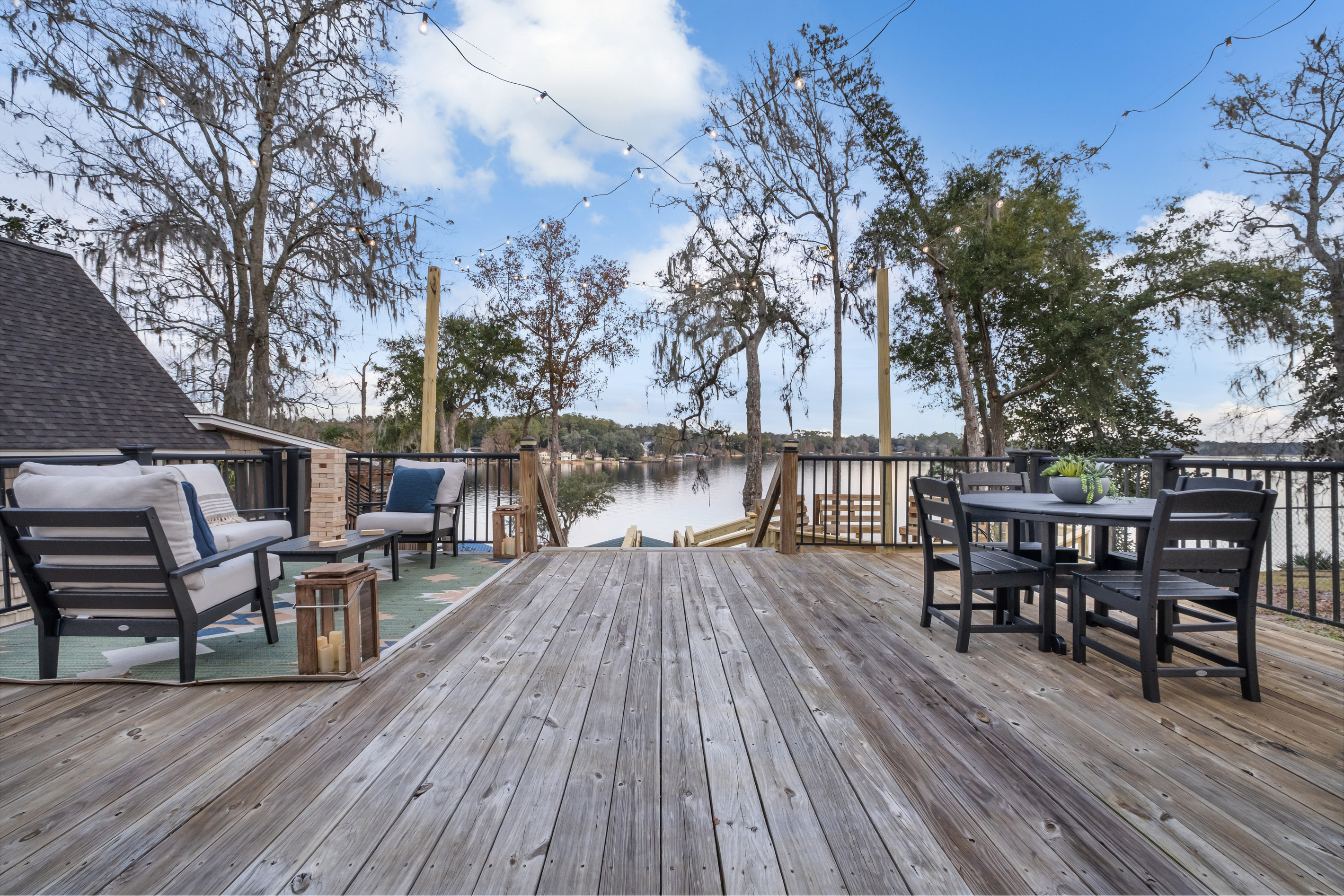 Deck with lake view, lounge seating and dining for 4