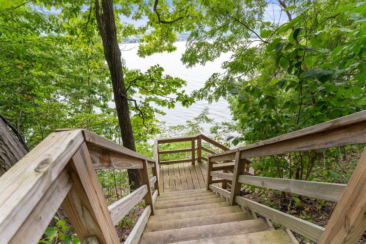 Scenic wooden stairs lead you through the trees to the shoreline, offering a serene start to every lake day.