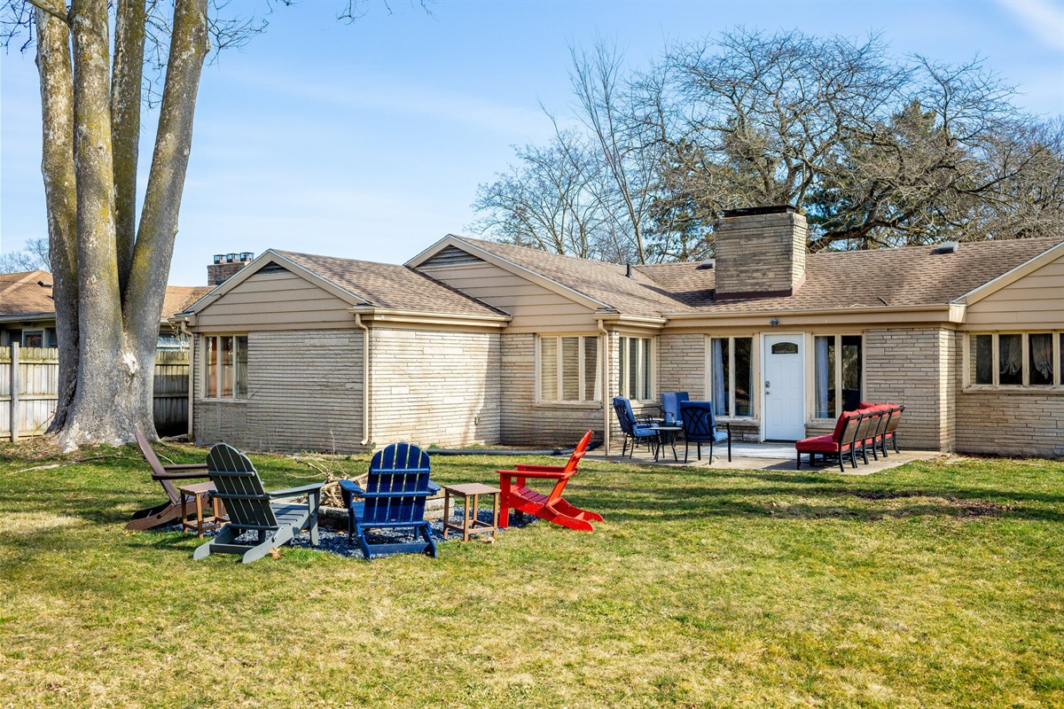 Great big fenced yard with outdoor seating and firepit