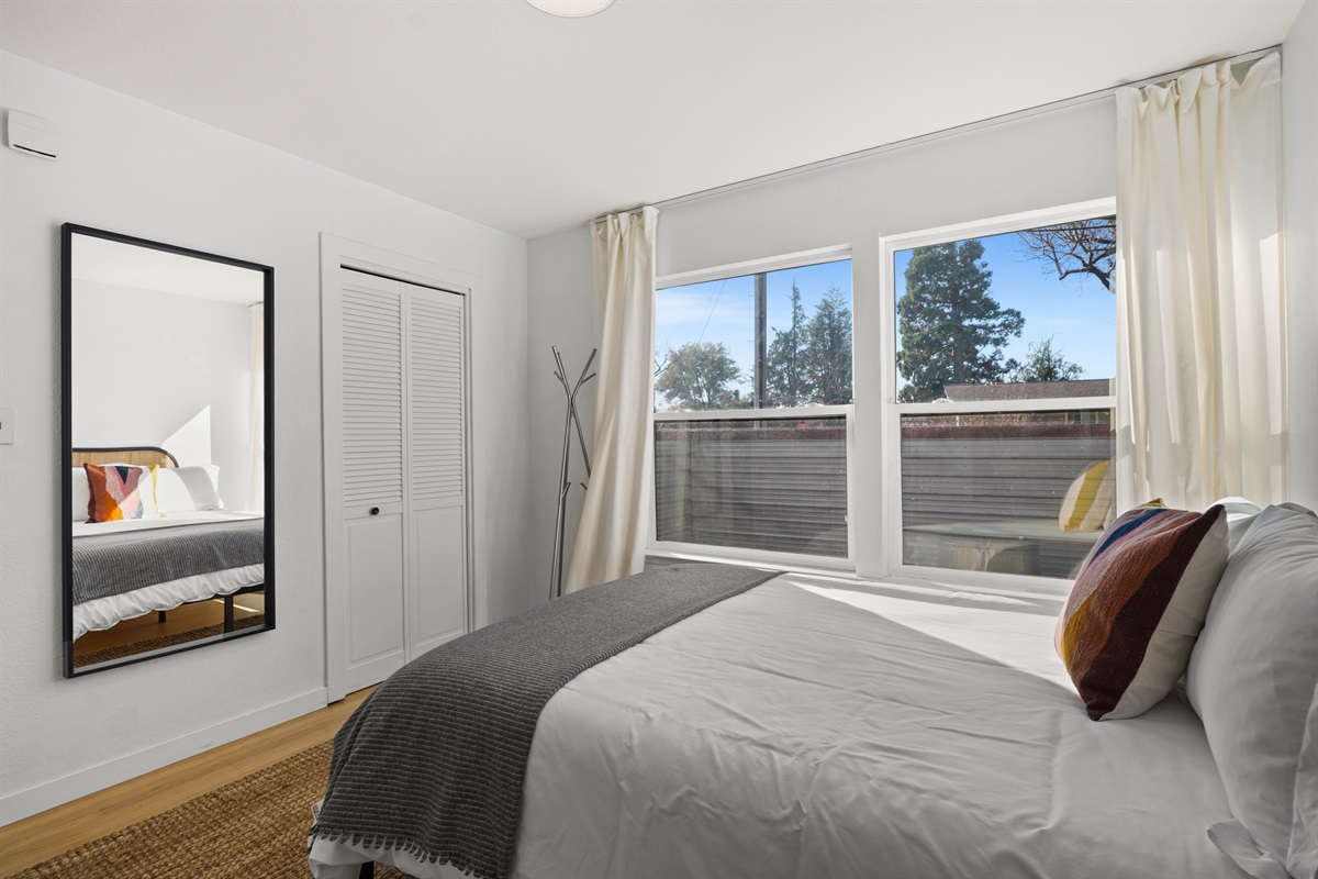 Inviting guest bedroom with a cozy queen bed, soft linens, and a peaceful atmosphere for a restful night's sleep.
