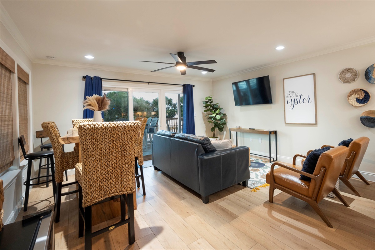 Professionally decorated living room with cozy seating, modern decor, and abundant natural light.