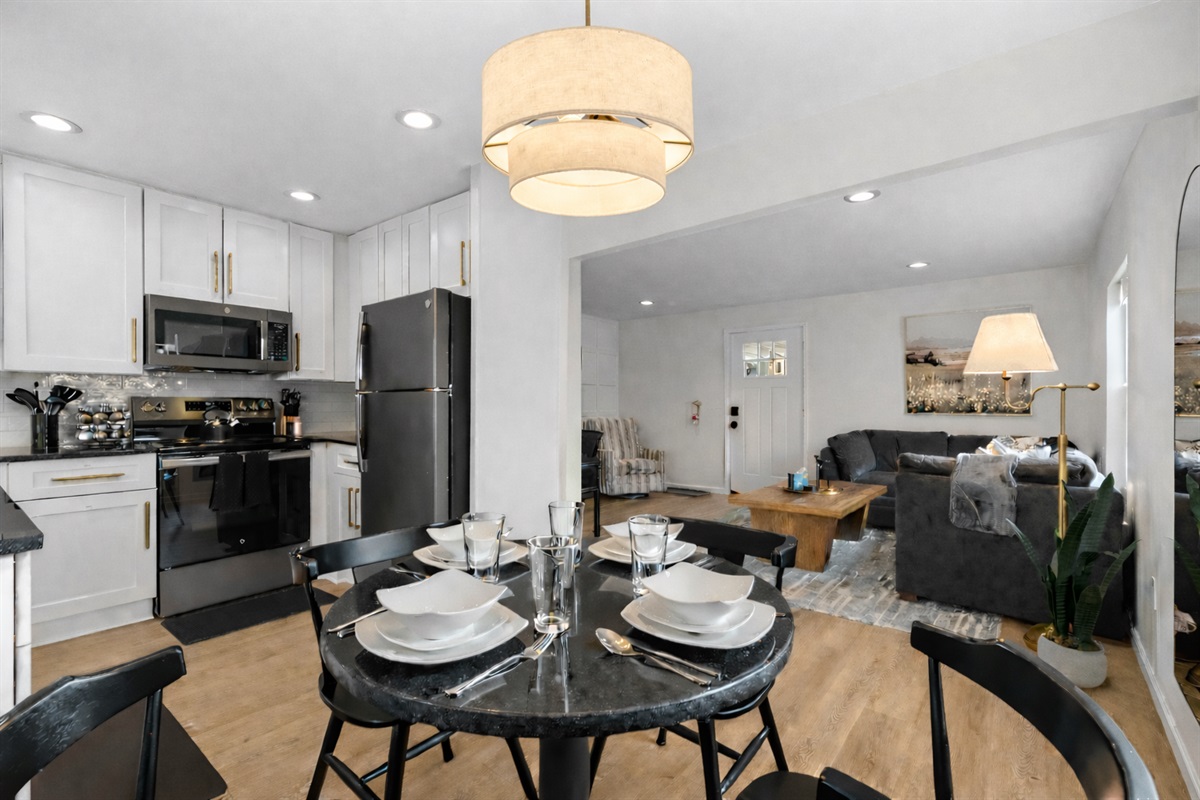 Open-concept kitchen and dining space with modern appliances, stylish lighting, and a seamless flow into the living area—ideal for cooking, dining, and relaxing together.