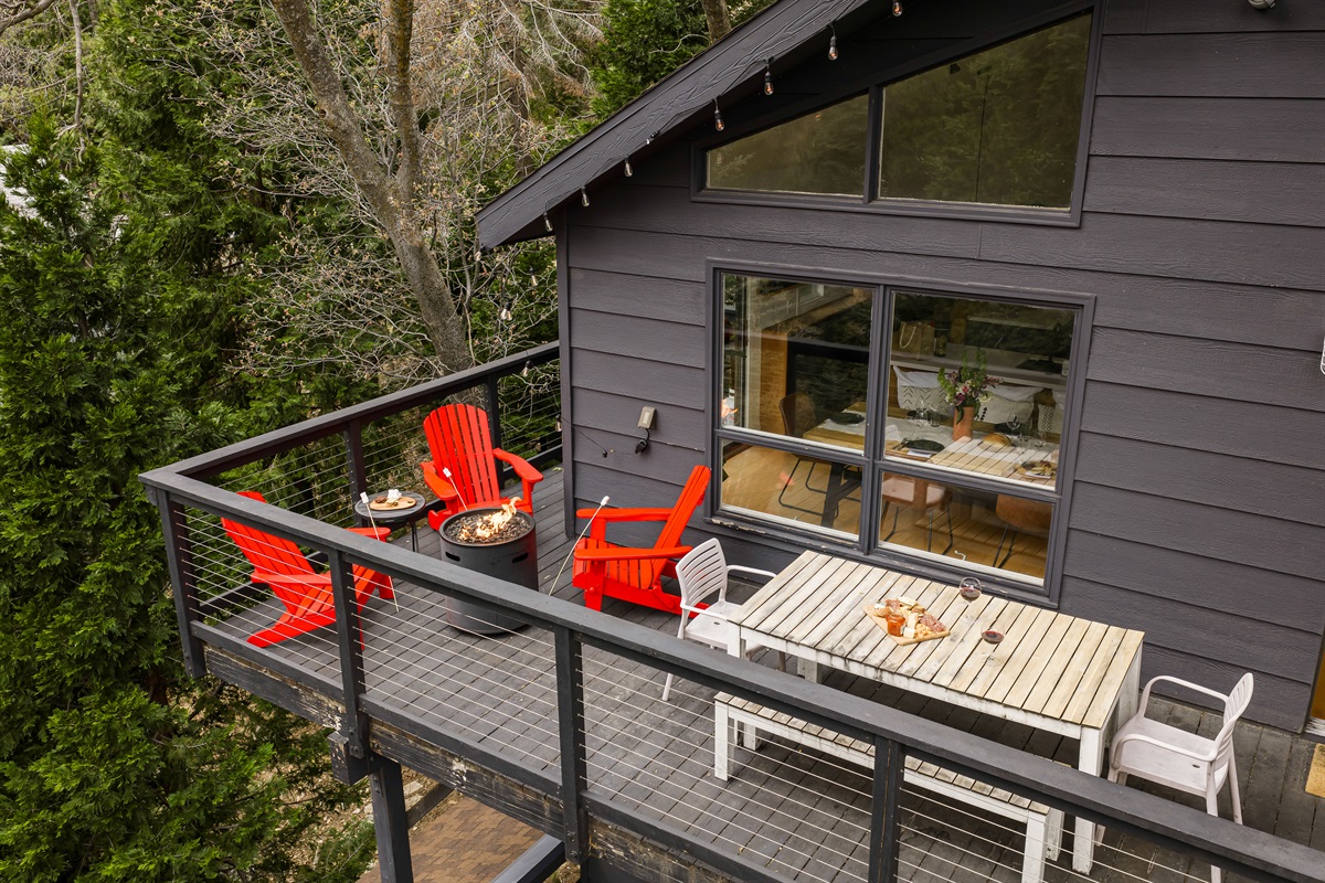 Private outdoor deck with fire pit, seating, and forest views—perfect for relaxing, dining outside, and enjoying a peaceful mountain cabin getaway in Lake Arrowhead.