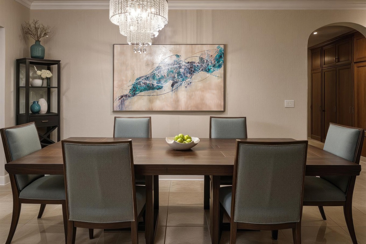 Dining table seats the group comfortably under chandelier