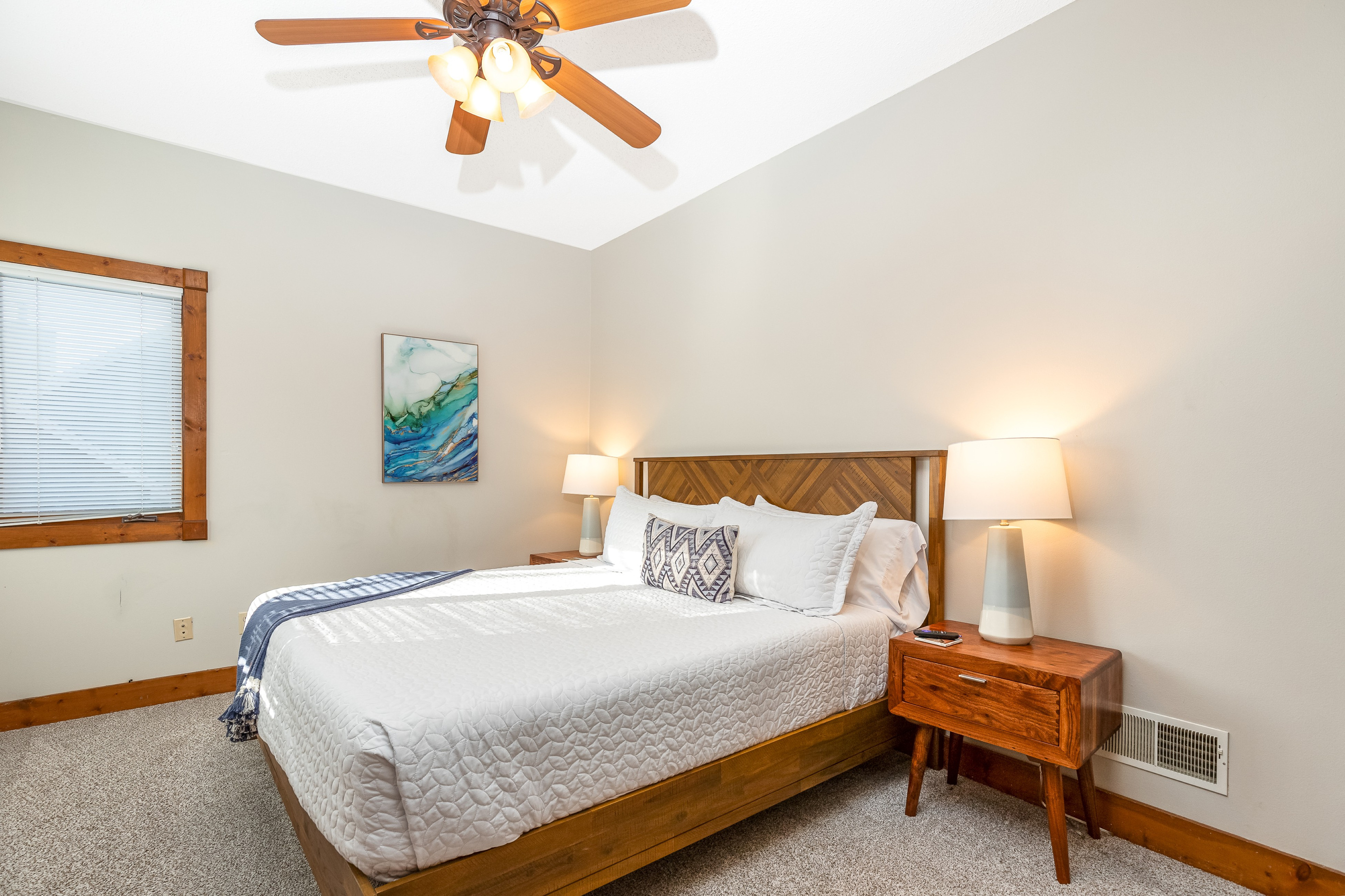 Bedroom 2 featuring a King bed and a Roku Smart TV, and a bathroom directly adjacent to the bedroom; one of two bedrooms located on the main floor.