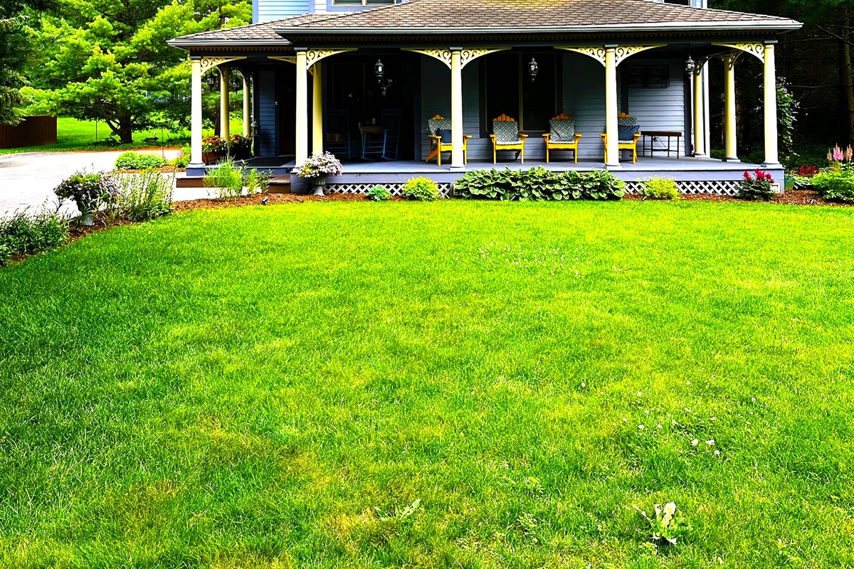 Springtime charm surrounds the home with colorful flowers and warm, welcoming vibes