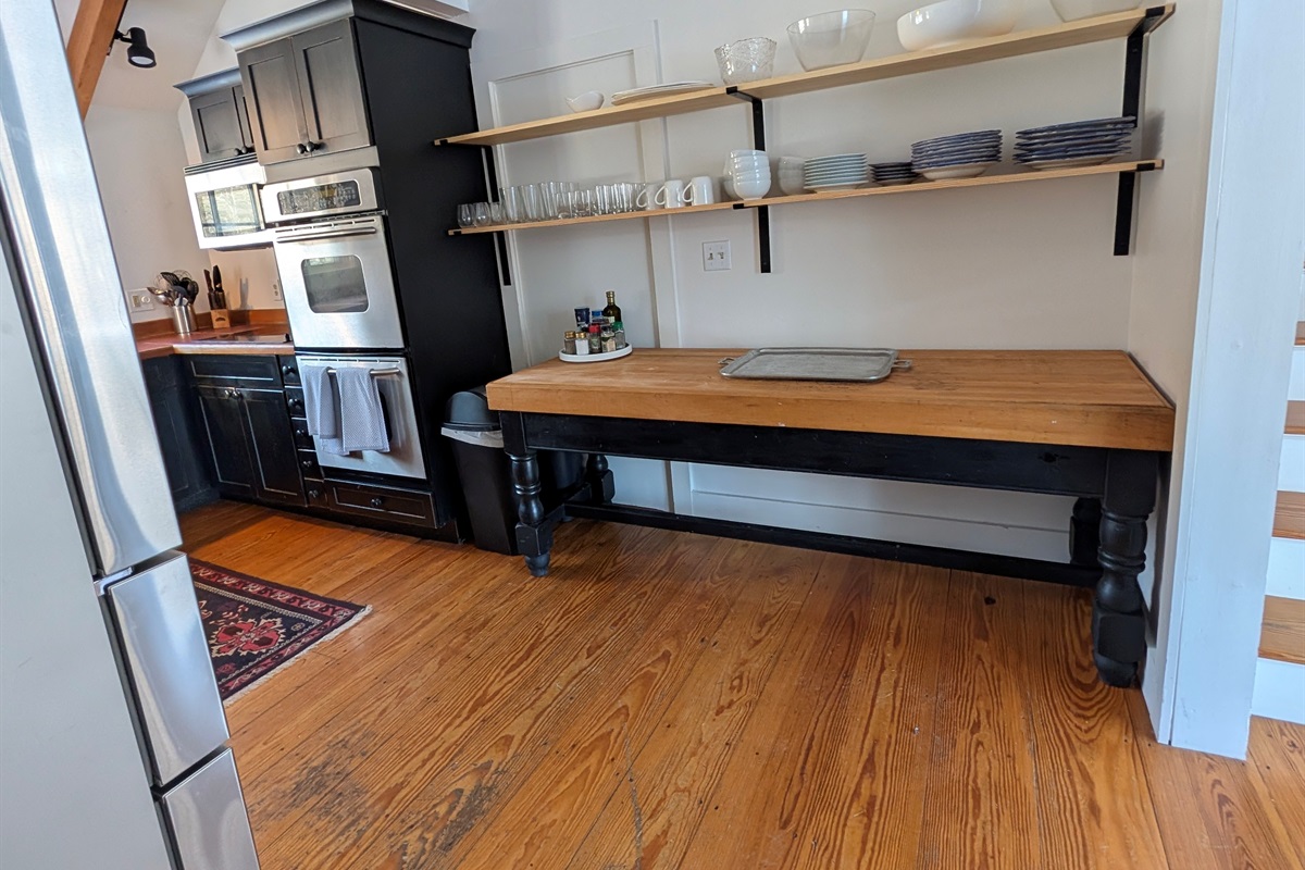 Generous counter space and open shelving make this kitchen area perfect for cooking, serving, and gathering.