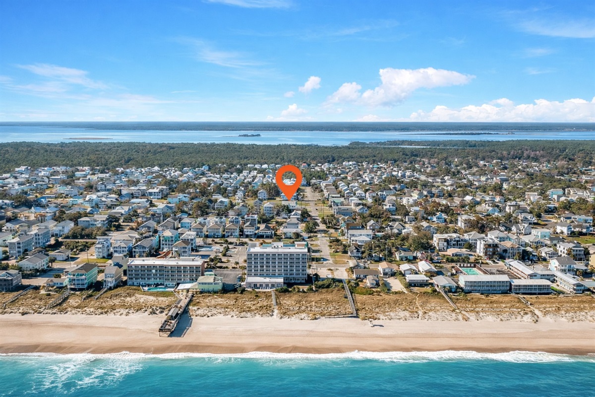 Aerial view showing the home’s location — just a 3-minute walk to the beach via a marked crosswalk where traffic stops.