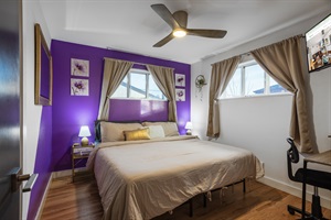 A room with a rich blend of purple and brown tones, featuring a lamp-lit study table for a warm and inviting learning environment.