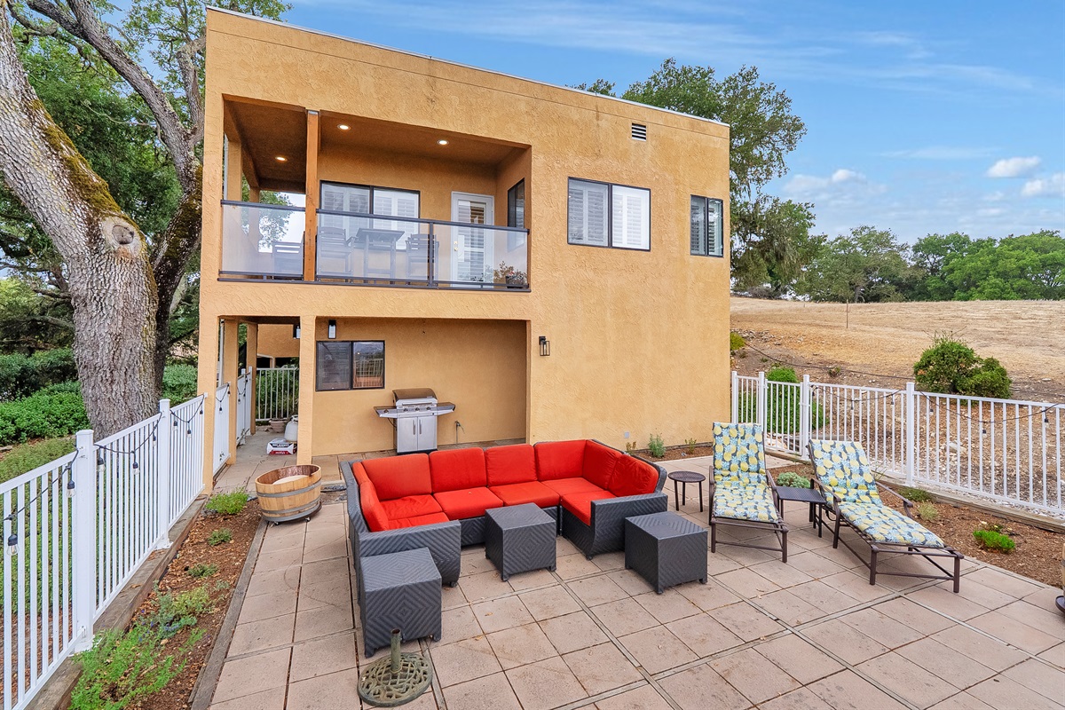 This stunning modern property offers multi-level outdoor enjoyment, featuring a spacious upper balcony off the main level and a lower, private patio perfect for grilling and lounging.