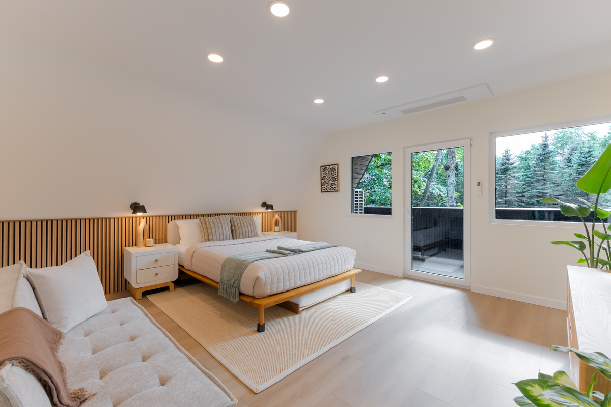 Queen bed with the balcony door right there