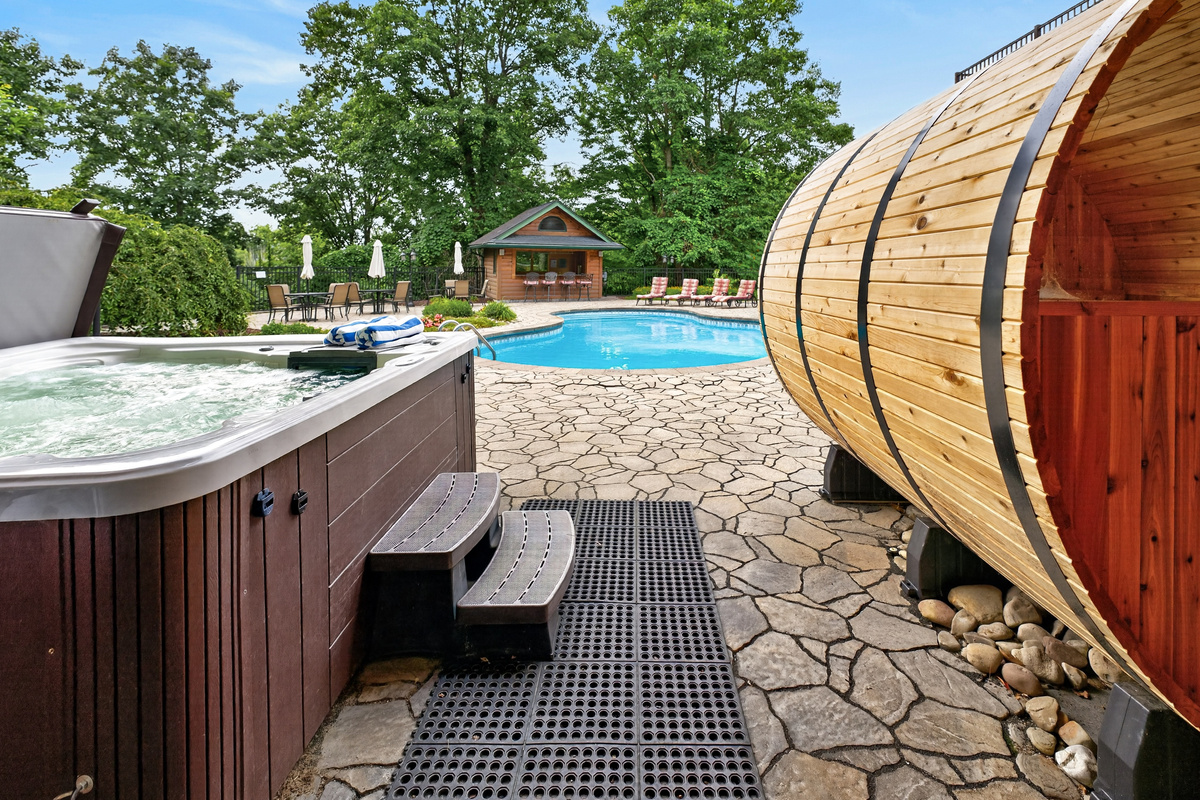 Barrel sauna beside the covered hot tub