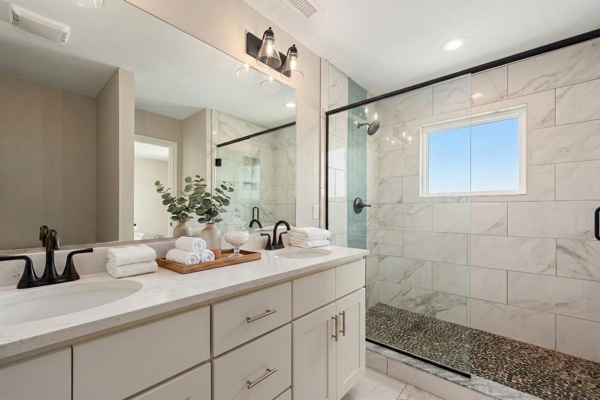 TL Bedroom 1 Bath - Luxurious spa-like bathroom with a spacious walk-in shower and dual vanity.