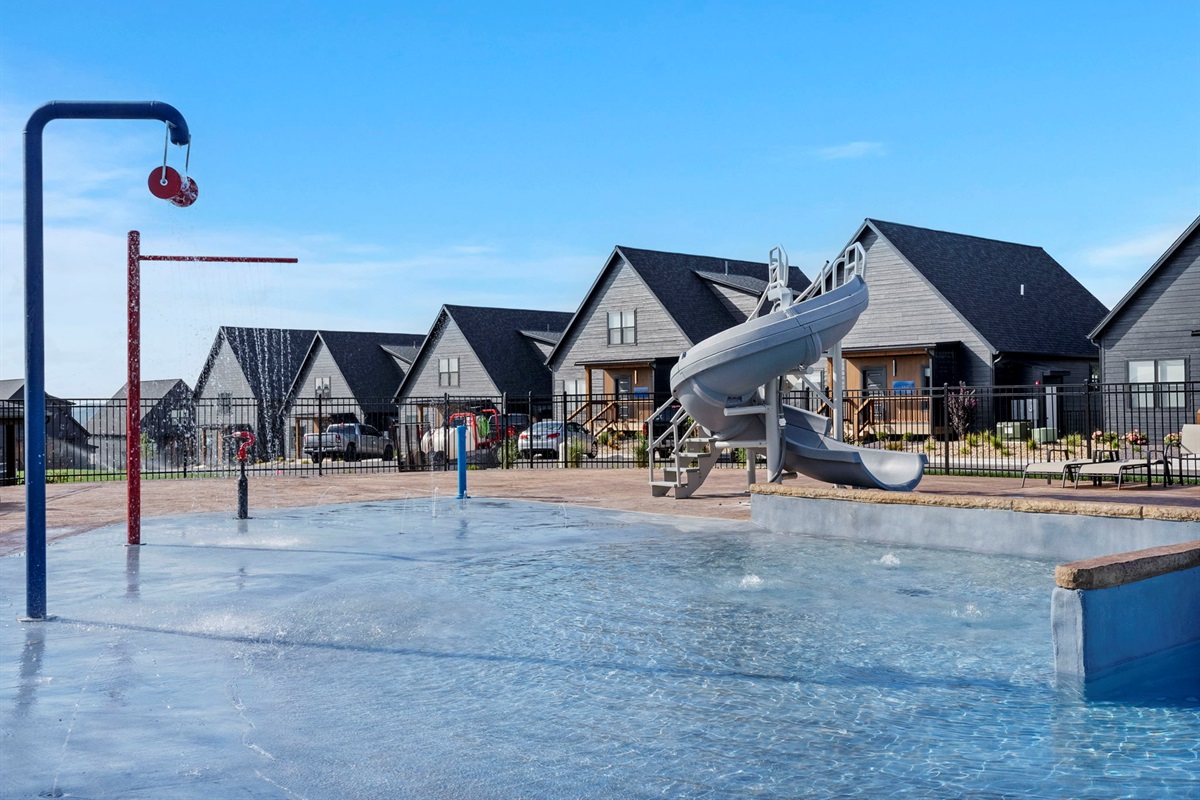 Outdoor community pool w/ slide and splash pad!