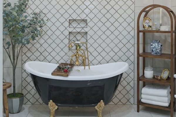 Beautifully styled bathroom with a classic clawfoot tub, elegant chandelier, and thoughtful touches for a relaxing, upscale retreat
