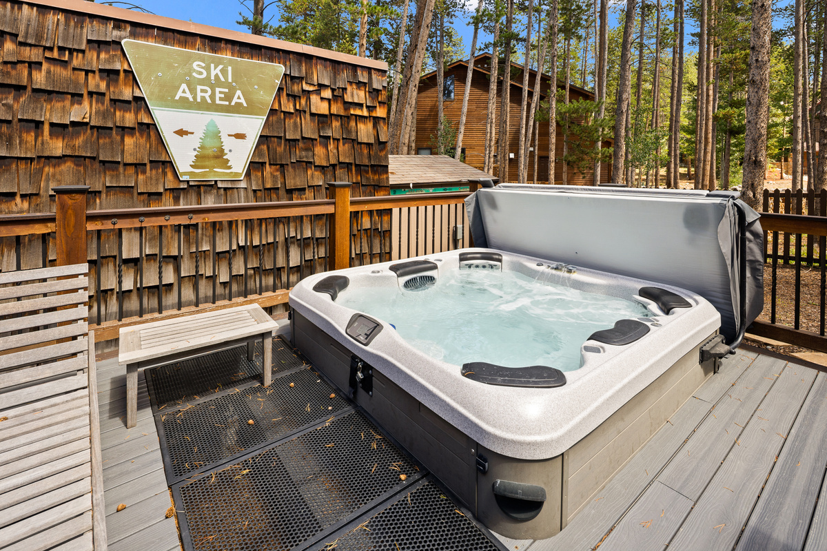 Partially-sunken private hot tub just steps out the back door on the deck