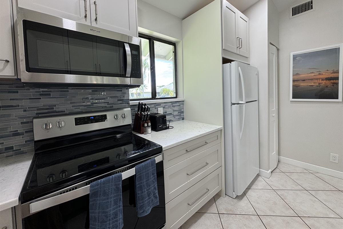 The galley-style kitchen is well-equipped with all the essentials needed to make home-cooked meals together.