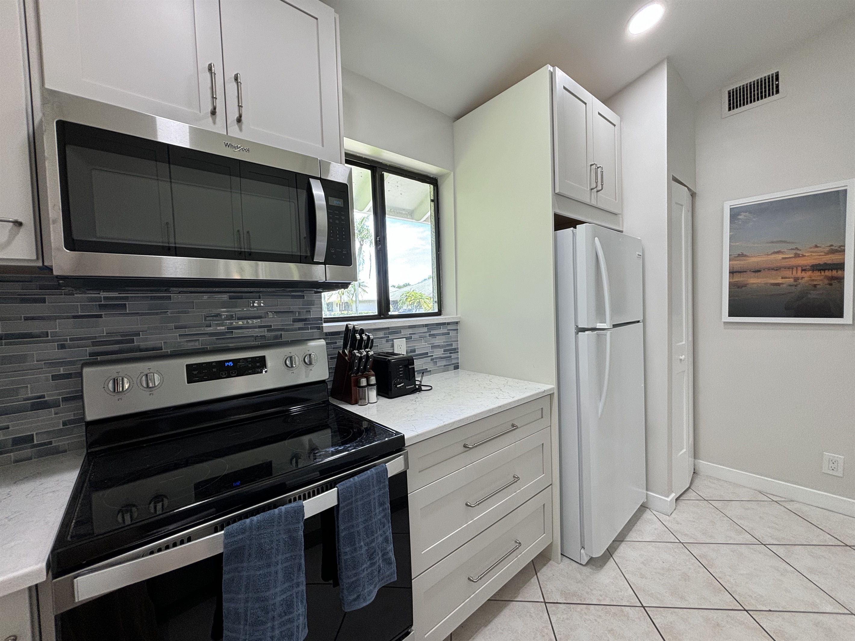 The galley-style kitchen is well-equipped with all the essentials needed to make home-cooked meals together.