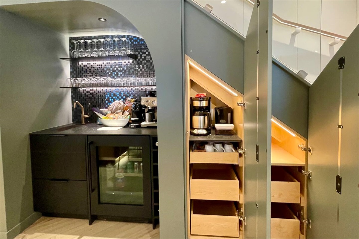 Hot & Cold Beverage station includes Expresso Coffee Machine, sink, drink fridge, pantry and sensational LED accent lighting.   